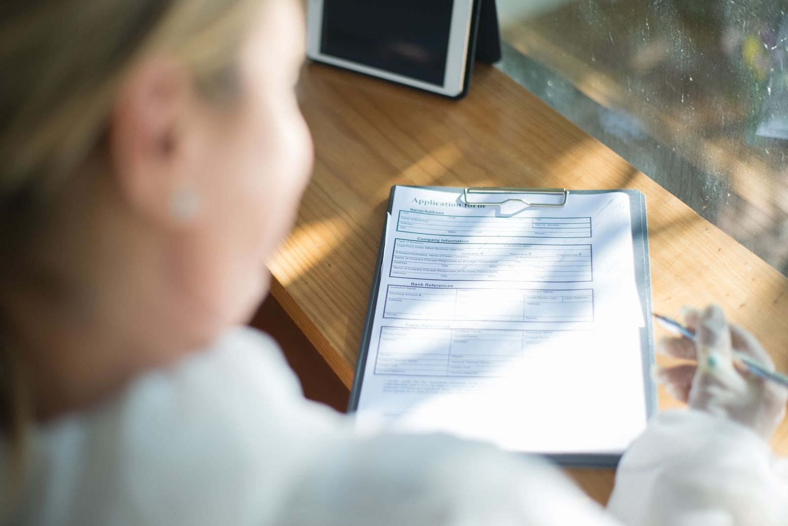 A person filling out an application form, representing CAPM certification requirements.