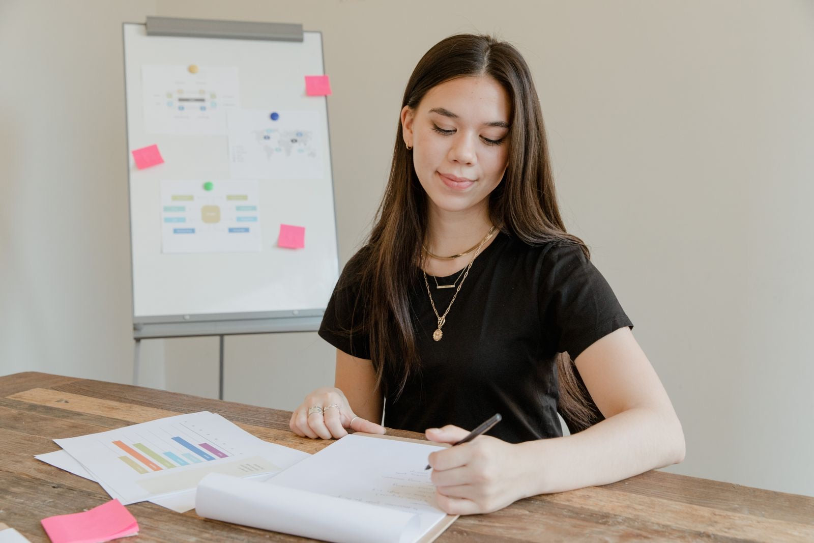 A young professional analyzing data and preparing a report at a desk, representing the CAPM certification.