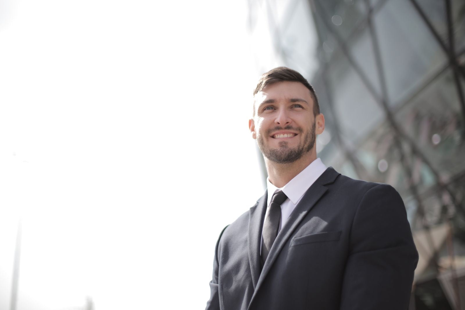A confident professional smiling, reflecting the career payoff of earning the PMP.