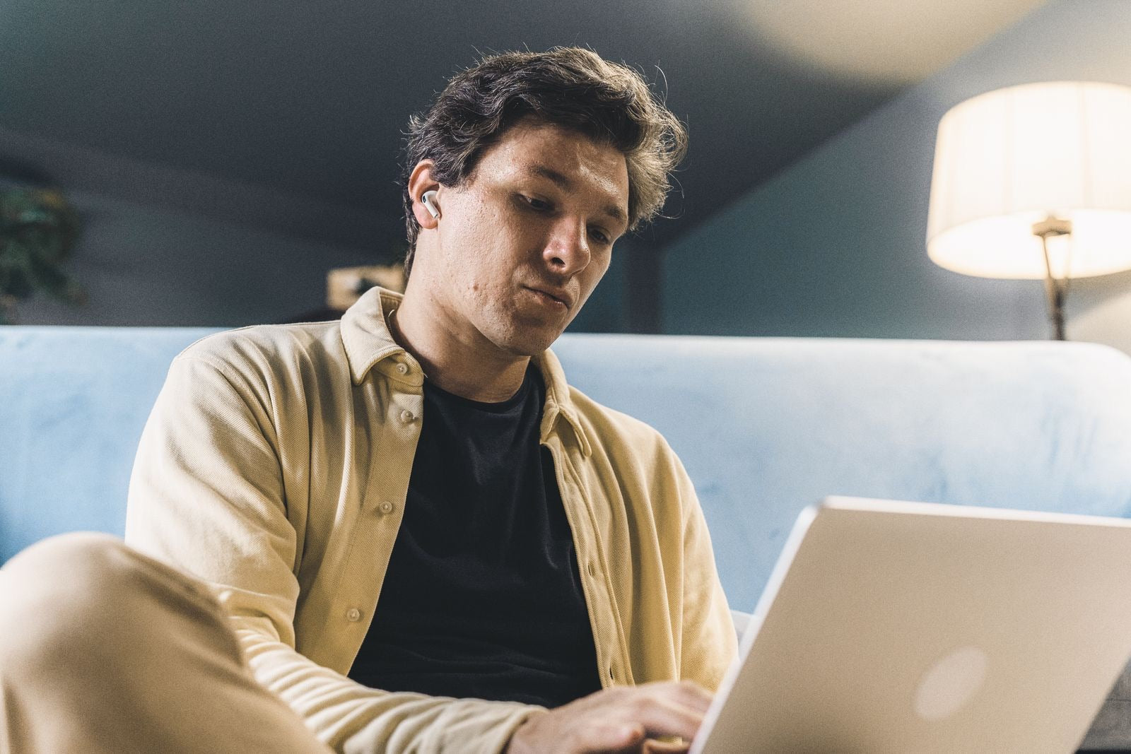 A thoughtful professional working on a laptop, considering how hard the CAPM exam is.