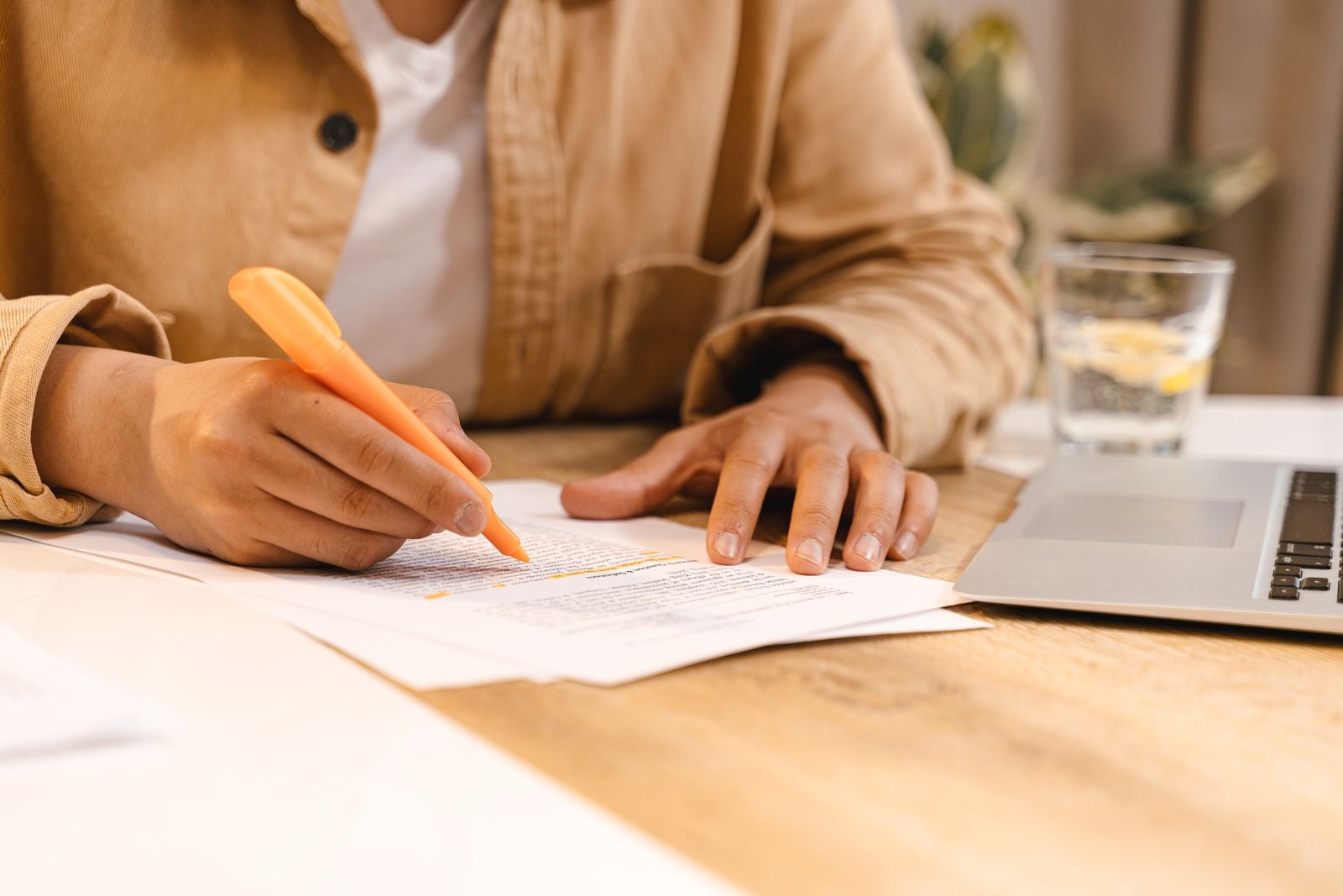 A candidate highlighting study notes while preparing to the PMP exam content outline.