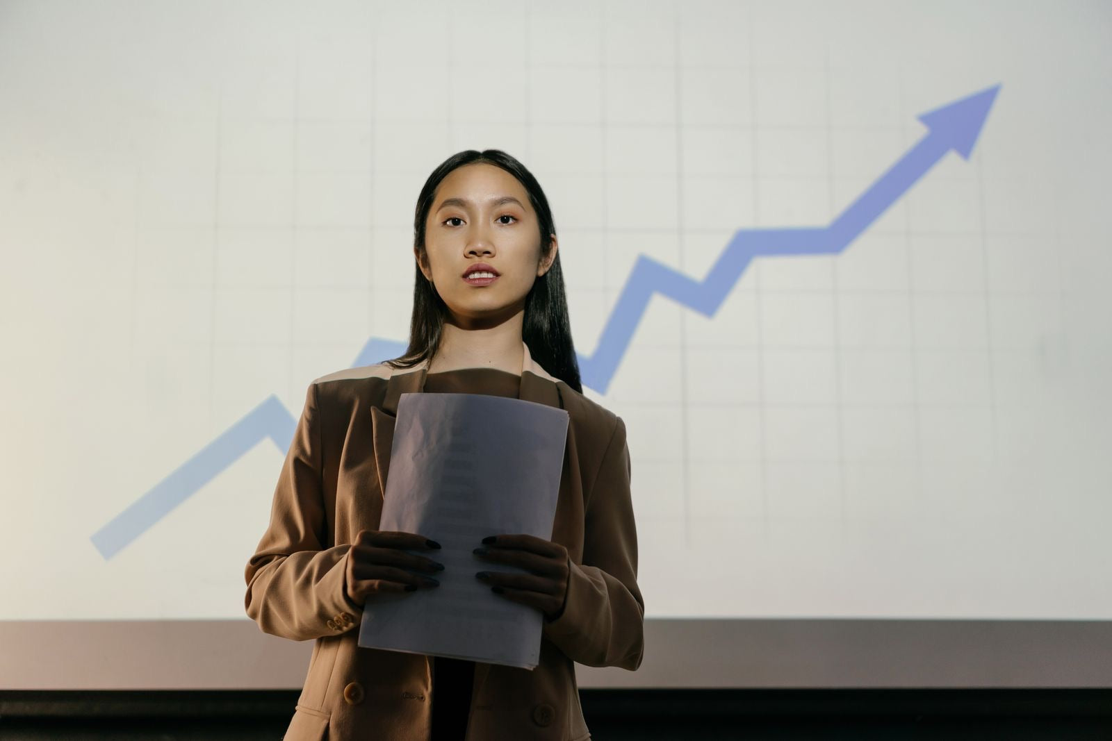 A confident project management professional presenting a growth chart, representing rising PMP certification salary.
